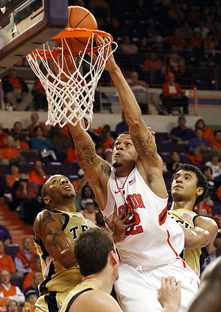 Clemson forward K.J. McDaniels dunks the ball over Georgia Tech's Kammeon Holsey, left and Chris Bolden in the first half of their game at Littlejohn Coliseum Tuesday night.