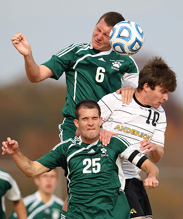 Lees-McRae College's Scott Hudgins, top left, and Luke Duffy go up for a header against Anderson University's Daniel Bowers in the first half of their game in Anderson Wednesday afternoon.